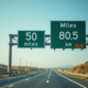 Panneau routier indiquant 50 miles et 80,5 km en plein jour